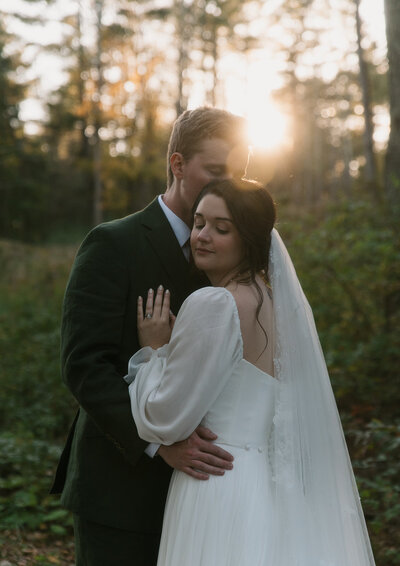 bride-embracing-groom-sunset-new-england-jemima-richards-photography