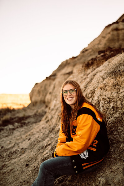 senior girl wearing her school lettermans jacket