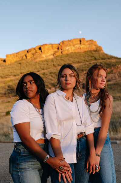 three women holding hands