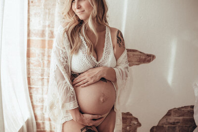 pregnant woman looking out window
