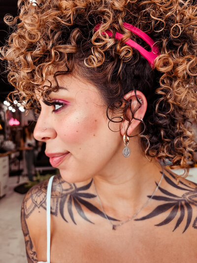 A client of Moxie by KC shows off her curly hair in an upstyle