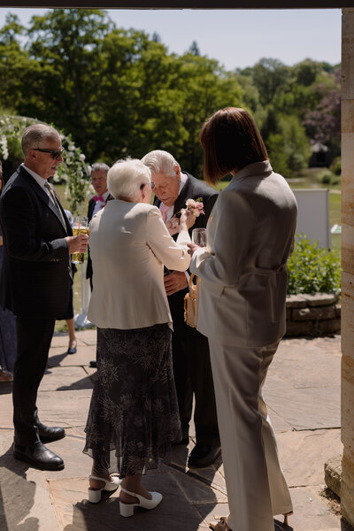 Wedding photographer captures couple taking a stroll hand in hand at their french chateau wedding.