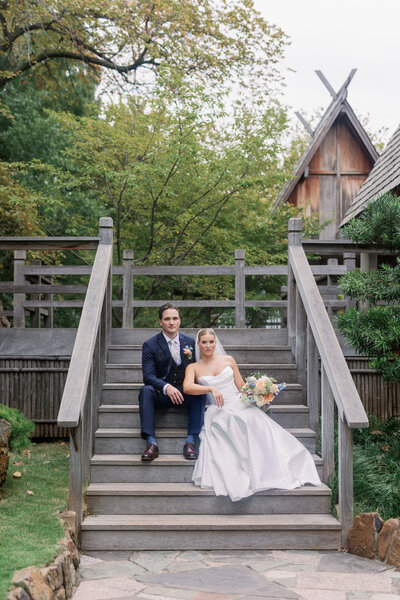 bride and groom sitting on stairs at fort worth botanic gardens at fall wedding by Kortney Boyett Photography, Fort Worth wedding photographer