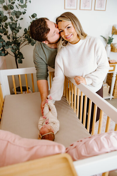 Mother posing candidly in a studio laughing with her toddler son