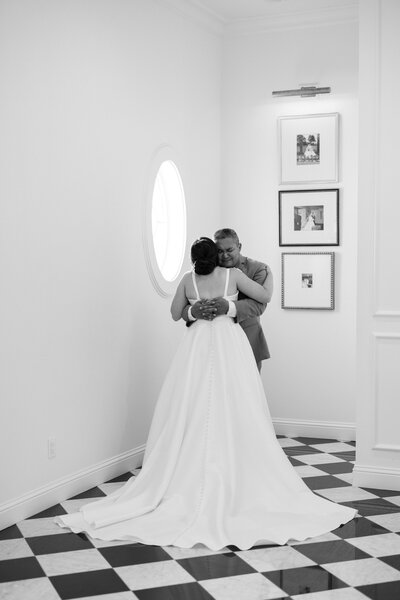 bride standing in the doorway in her bridal gown