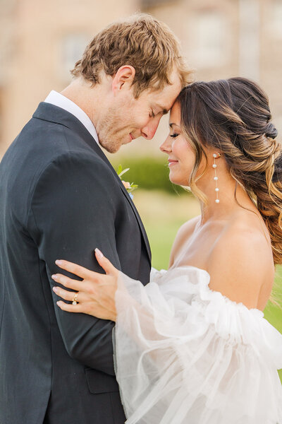 Bride and groom sharing a romantic moment at their wedding in Highlands Ranch at the Highlands Ranch Mansion in Colorado. 