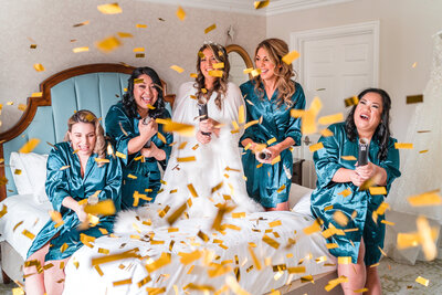 Fun confetti shot with bridesmaids at Disney wedding by top Orlando photographer
