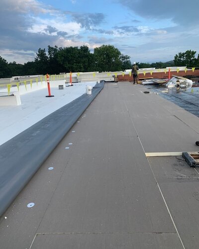 Newly installed rubber roofing, EPDM and TPO, on a commercial building with a flat roof 