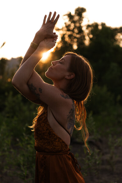 woman doing a yoga pose in the sun