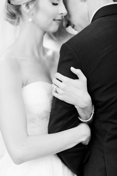 Black and White photo of bride and groom embracing on wedding day