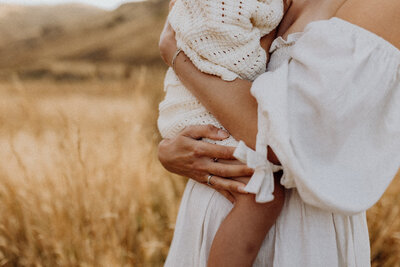 a close up image of the baby held in the mothers arms showing the connection between mother and daughter, taken in canterbury by lucy jane photography