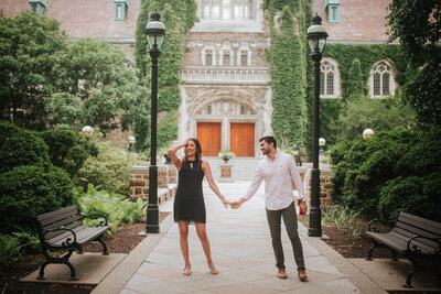 Lehigh Valley engagement session couple holding hands while groom glances at wife-to-be.