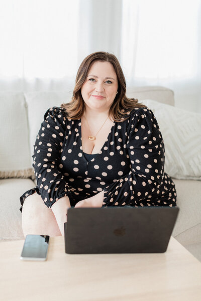 Warm, friendly headshot of luxury brand designer Sarah Shuttle in a cosy cardigan.