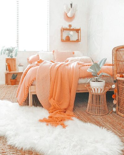 Soft and natural looking bedroom in creams and oranges
