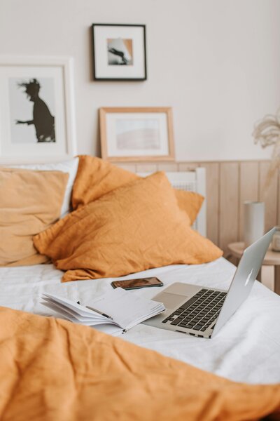 Laptop and phone in bed