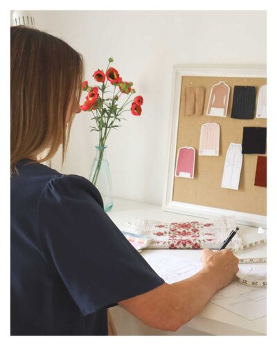 Fashion designer Doreen working on sketches for a new client project.