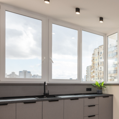 Modern style kitchen with a casement window above the sink with white casing. This window can open up outwards to provide fresh airflow and natural light.