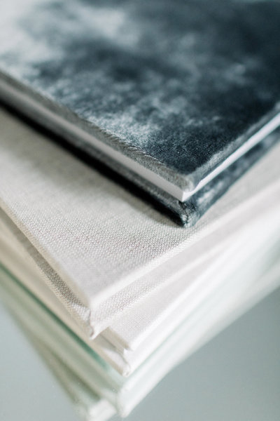 samples of fresno newborn photographer heirloom albums. linen, velvet, leather