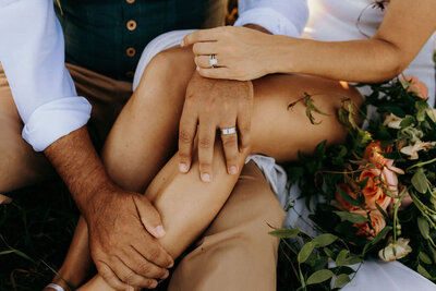 photo of man and woman sitting on the ground with their legs and arms touching taken by Jackson Hole destination wedding photographer