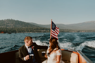 Newlyweds celebrating on boat in Lake Tahoe after elopement ceremony