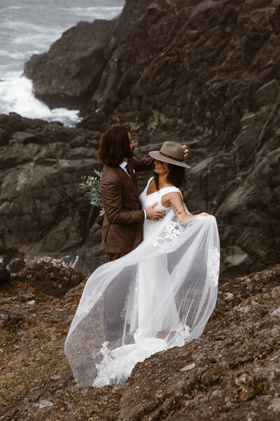 bride and groom on rocks