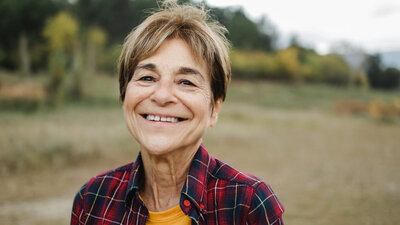 Adult person smiling outside embracing mental health healing
