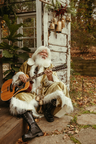 A fun retro santa sitting at Das hinterhaus with his guitar.