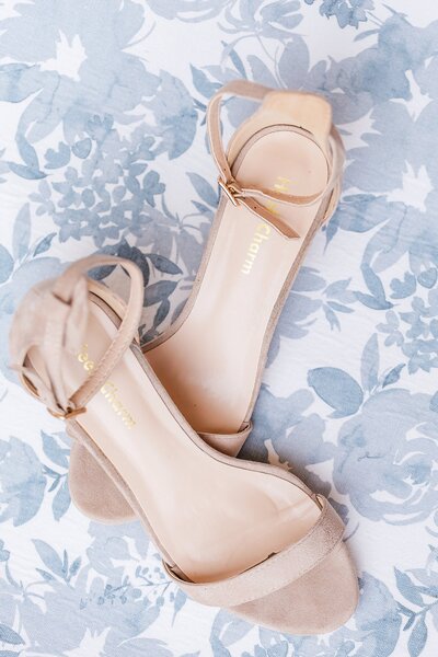 Bridal shoes on blue floral backdrop - flat lay image by Alabama wedding photographer Amanda Horne