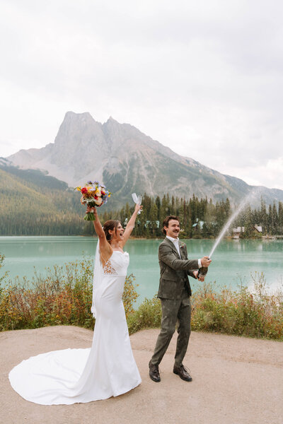 wedding couple sitting in wildflowers at banff national park