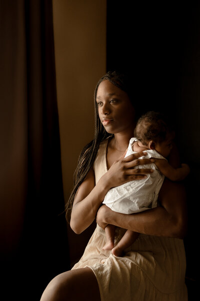 mother holding newborn against her chest
