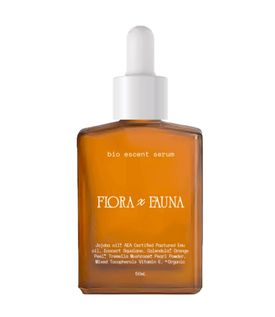 A square-shaped amber glass bottle of Flora x Fauna's Bio Accent Serum, featuring a dropper cap. The label showcases the brand’s name in elegant typography, with details about the serum's natural and organic ingredients, including certified plant-based oils. The clean, minimalist design emphasizes the product's eco-friendly and high-quality formulation.