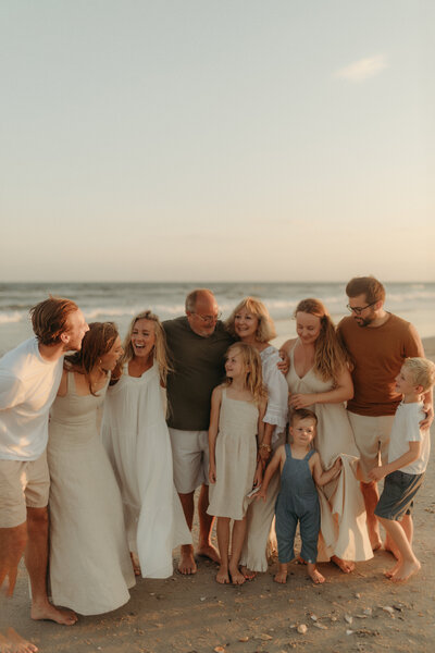 Extended family beach photoshoot at sunset in Virginia