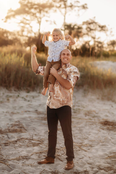 Father holds his son during Family Photos on Folly Beach.