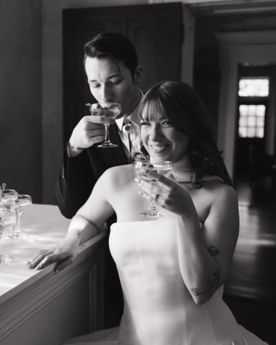Editorial Bride and groom toasting at Riverwood Mansion 
