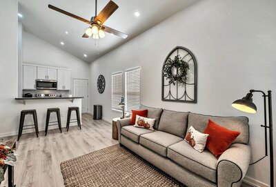 Living area and bar seating in this 2-bedroom, 1 bathroom vacation rental home located 4 minutes from delicious Magnolia Table and 5 minutes from the beautiful Baylor campus in Waco, TX