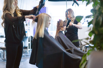 Stylist with client at blow dry bar