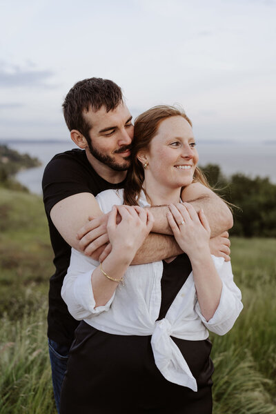couple hugging engagement shoot at Discovery Park