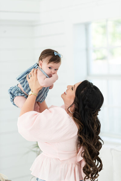 mother lifting up baby headshot of miami maternity photographer MSP Photography David and Meivys