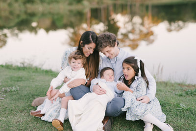 Family sitting in grass at Chase Lake Park in Hoover AL by Olivia Joy Photography