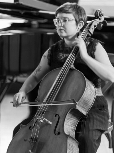 Black and white photo of woman playing a cello