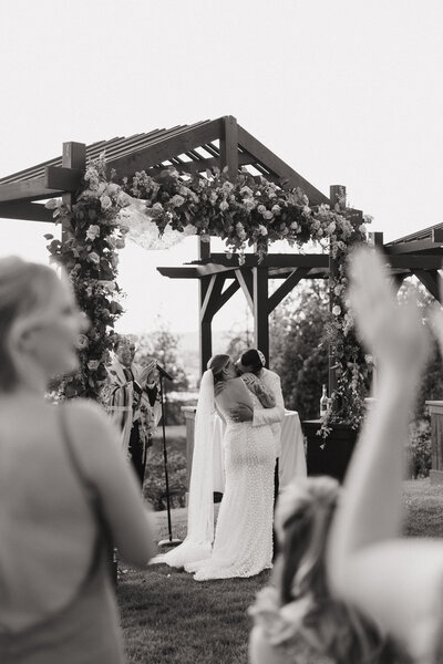 black and white image of couple sharing first kiss
