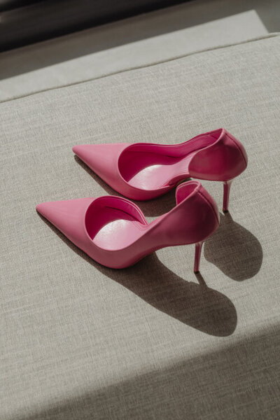 pink heels on a beige sofa