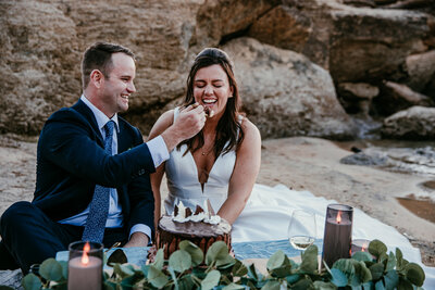 Groom feeding bride a bite of chocolate cake during an intimate elopement celebration in San Francisco.