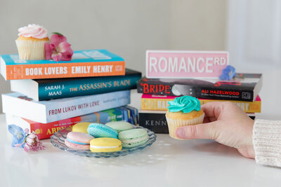 Stacked books with cupcakes, macarons and flowers