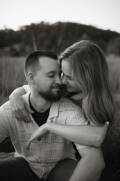 Portrait of Stephen and Kaity from Rainstorm Photo & Video sharing a quiet, joyful moment outdoors — captured in warm light to reflect their love and documentary approach to wedding photography.
