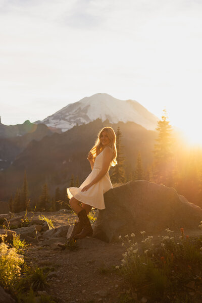 cowgirl in boots with mount rainier in the background golden hour at Mount Rainier National Park 