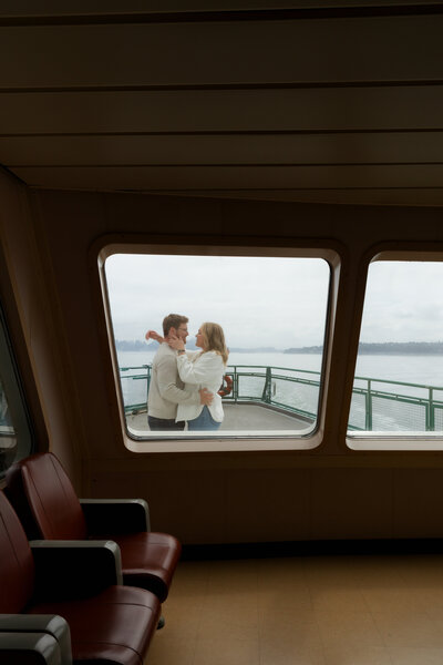 This sweet moment from this Seattle ferry session still feels like a scene out of a movie. Wrapped up in each other on the deck, with the Puget Sound behind them and ferry windows framing it all so perfectly—this is what laid-back, natural love looks like. If you're dreaming of an intimate Pacific Northwest engagement session with a view, this is your sign.