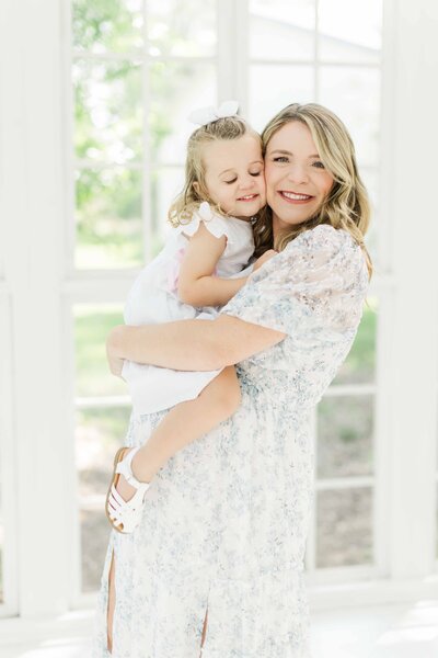 Mom and daughter embrace for maternity photo session in houston 