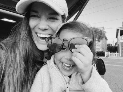 black and white iPhone photo of a mom and daughter laughing together