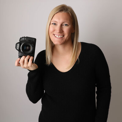 blonde headshot with a camera
